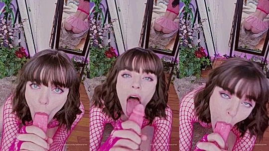 Ashe Maree sucking on a big dildo in her red fishnet bodysuit